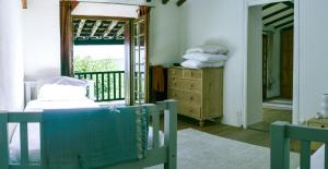 a bedroom with a bed and a window and a mirror at Mas Lartigues in Taurinya