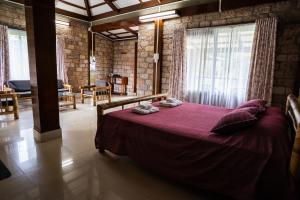 a bedroom with a purple bed in a room at Nohsngithiang Estate in Borpāni
