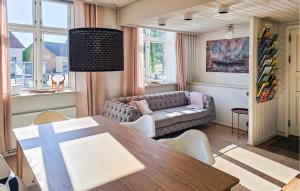 a living room with a table and a couch at 3 Bedroom Pet Friendly Apartment In Faaborg in Faaborg