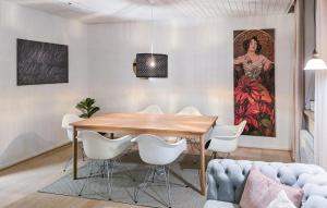 a dining room with a wooden table and white chairs at 3 Bedroom Pet Friendly Apartment In Faaborg in Faaborg