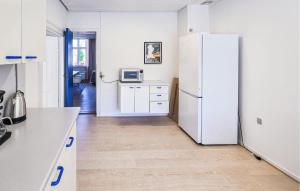 a kitchen with a white refrigerator in a room at 3 Bedroom Pet Friendly Apartment In Faaborg in Faaborg +12 photos