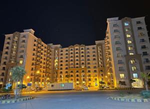a large building with a parking lot in front of it at bahria enclave apartments in Islamabad