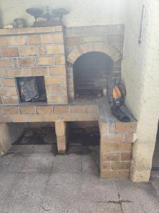 a brick oven sitting next to a wall at Villa Oasis Bollène in Bollène +4 photos