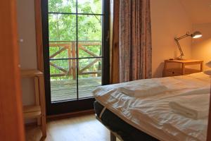 a bedroom with a bed and a large window at Bondyrz 134 in Bondyrz
