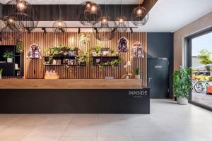 a store front with plants on the wall at INNSiDE by Meliá Luxembourg in Luxembourg