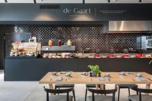 a restaurant with a table and chairs in front of a counter at INNSiDE by Meliá Luxembourg in Luxembourg