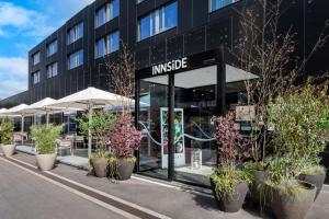 a large building with plants in front of it at INNSiDE by Meliá Luxembourg in Luxembourg