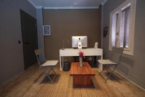 a room with a desk with a laptop computer on it at Kalkan Ayapa Hotel in Kaş