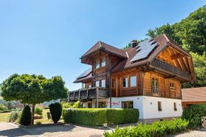 a wooden house with a roof at Haus am Wald in Münstertal