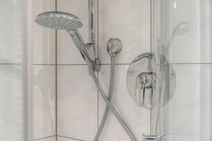 a shower with a shower head in a bathroom at Haus Christian und Hanni in Bad Kohlgrub +19 photos