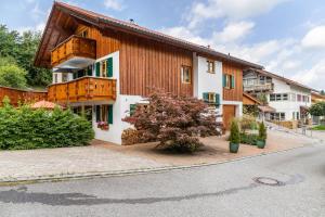 a building with a tree in front of it at Haus Christian und Hanni in Bad Kohlgrub