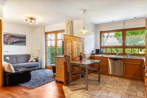 a kitchen with a table and a couch at Haus am Wald in Münstertal