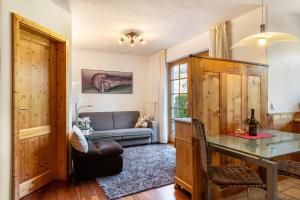 a living room with a couch and a table at Haus am Wald in Münstertal +24 photos