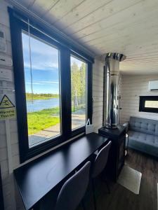 a room with a table and chairs and a window at Aurora Forest Cabin in Rovaniemi
