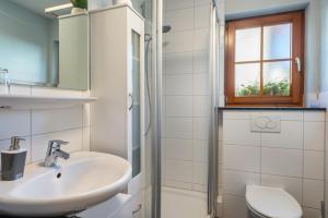 a bathroom with a sink and a toilet at Haus am Wald in Münstertal