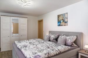 a bedroom with a bed and a ceiling fan at Haus Christian und Hanni in Bad Kohlgrub