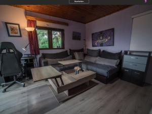a living room with a couch and a table at Beutiful view Cosy House with Starlink internet in Salamina