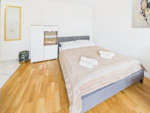 a bedroom with a bed with two towels on it at Śląskie Mieszkania in Będzin
