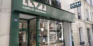 a store front with a green sign on a building at Espace entier Centre de Paris in Paris