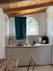 a kitchen with a sink and a window at Studio Apartments in Monemvasia