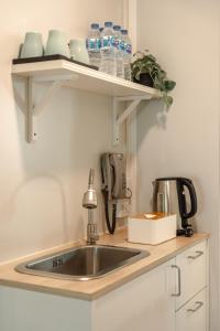 a kitchen counter with a sink and a phone at Gate43 Garden Villa in Lat Krabang +45 photos