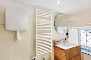 a bathroom with a sink and a mirror at Aura Suites in Albenga +14 photos