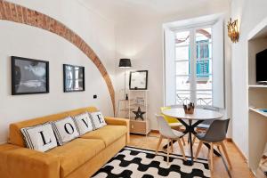 a living room with a couch and a table at Aura Suites in Albenga