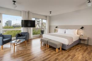 a hotel room with a bed and a large window at Almarena Madero Urbano, Affiliated by Meliá in Buenos Aires +45 photos