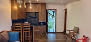 a kitchen with wooden cabinets and a counter top at Serene Slopes in Vagamon