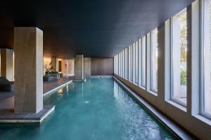 a swimming pool in a building with windows at Almarena Puerto Retiro, Affiliated by Meliá in Buenos Aires