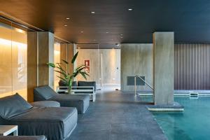 a hotel lobby with a swimming pool and furniture at Almarena Puerto Retiro, Affiliated by Meliá in Buenos Aires