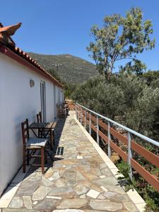 a patio with a table and chairs on a house at Studio Apartments in Monemvasia