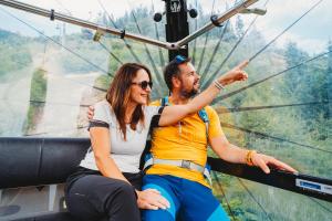 a man and a woman riding on a roller coaster at Hotel Srdiečko in Tale