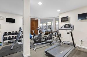 a gym with two treadmills and cardio machines at Keepers Cottage - Dartmouth Golf and Spa Resort in Dartmouth