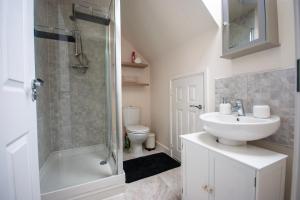 a bathroom with a sink and a shower and a toilet at Spacious Luxurious Serviced Accommodation 2 in Coventry +17 photos