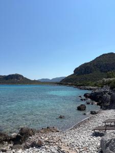 a beach with rocks and the water at Studio Apartments in Monemvasia +1 photo