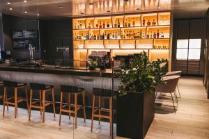 a bar in a restaurant with stools at NH Collection San Sebastián Aranzazu in San Sebastián