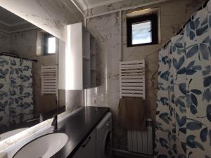 a bathroom with a sink and a mirror at Aziz House in Naryn