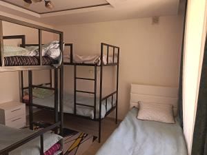 a room with three bunk beds and a bed at Nanik Hostel in Khorog