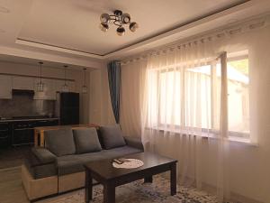 a living room with a couch and a table at Nanik Hostel in Khorog