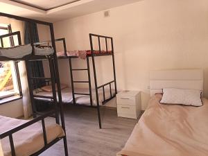a room with four bunk beds and a bed at Nanik Hostel in Khorog