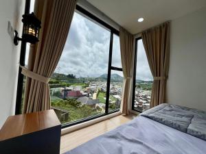 a bedroom with a bed and a large window at Oemah Ntuy Full view in Diyeng
