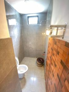 a small bathroom with a toilet and a sink at Oemah Ntuy Full view in Diyeng