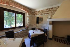 a dining room with a table and a window at Nascar Hotel in Santa Maria Navarrese