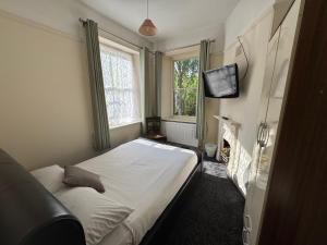 a small bedroom with a bed and a television at The Briary in Sheffield