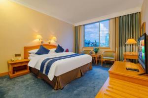 a hotel room with a bed and a television at Kunming Hotel in Kunming +291 photos