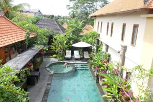 a swimming pool in the middle of a house at Villa Cilinaya Ubud in Ubud