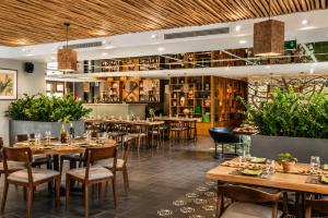 a restaurant with tables and chairs and a bar at G8 Center Hotel Saigon in Ho Chi Minh City