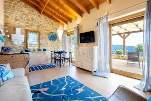 a living room with a couch and a kitchen at Nous Village 2 in Alyki