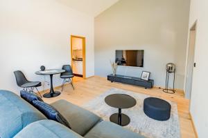 a living room with a blue couch and a table at Gut Buchenhof in Buchenberg